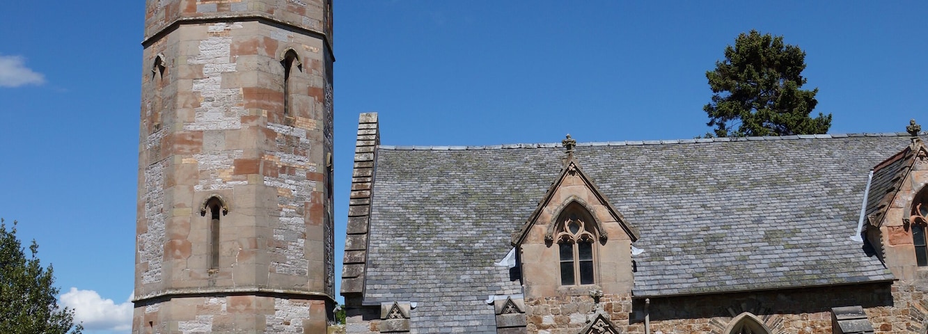 West tower, spire and south porch of the parish church of St Michael the Archangel, Llanyblodwel, Shropshire, England