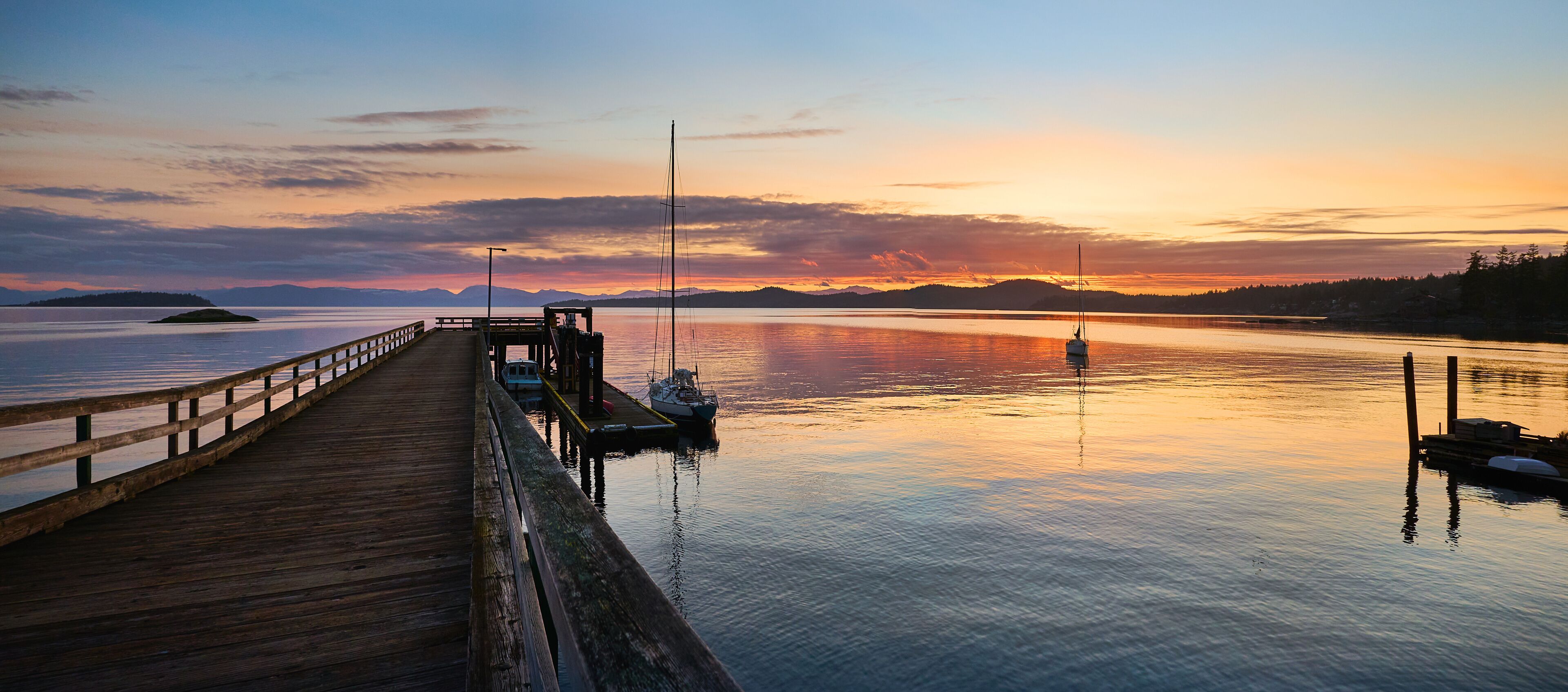 sailboat at the pier. Sunset over the sea Halfmoon Bay. Sunshine Coast, British Columbia, Canada