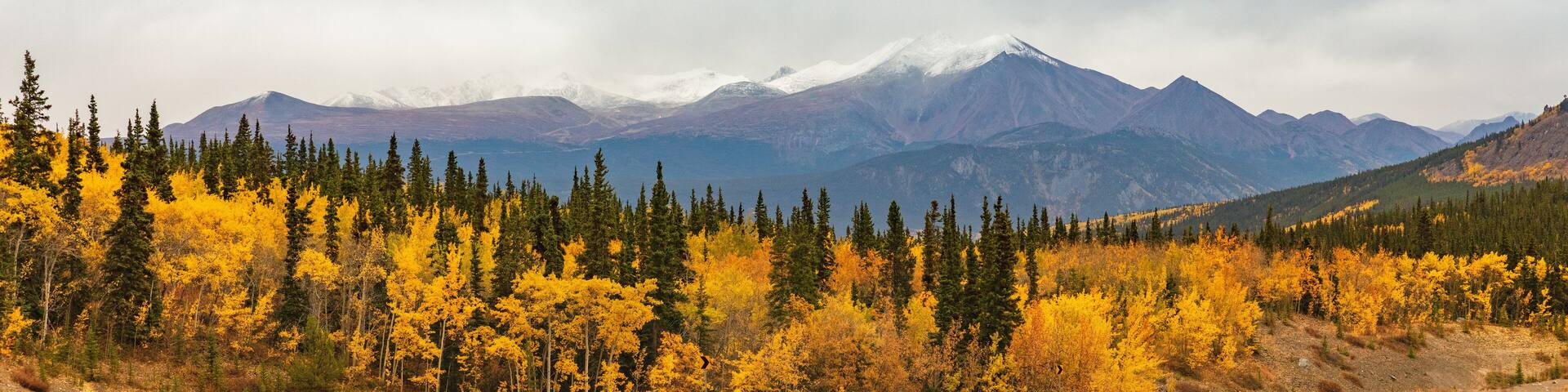 Alaska mountains landscape nature background in autumn fall season. Snow peaks banner panorama.