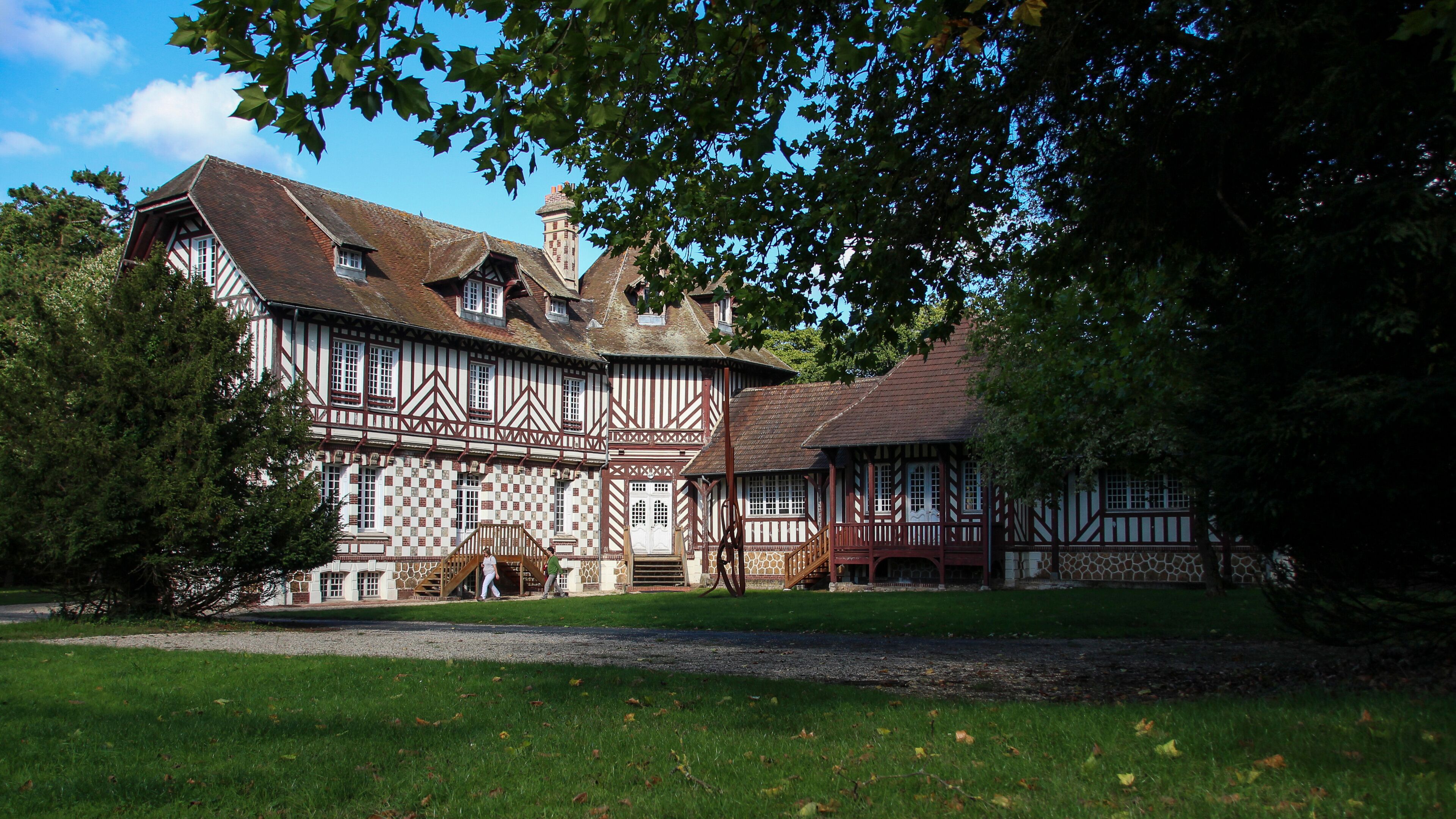 A Tudor-style building with a steeply pitched roof and timber framing.