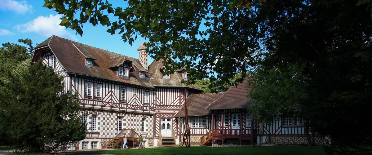 A Tudor-style building with a steeply pitched roof and timber framing.