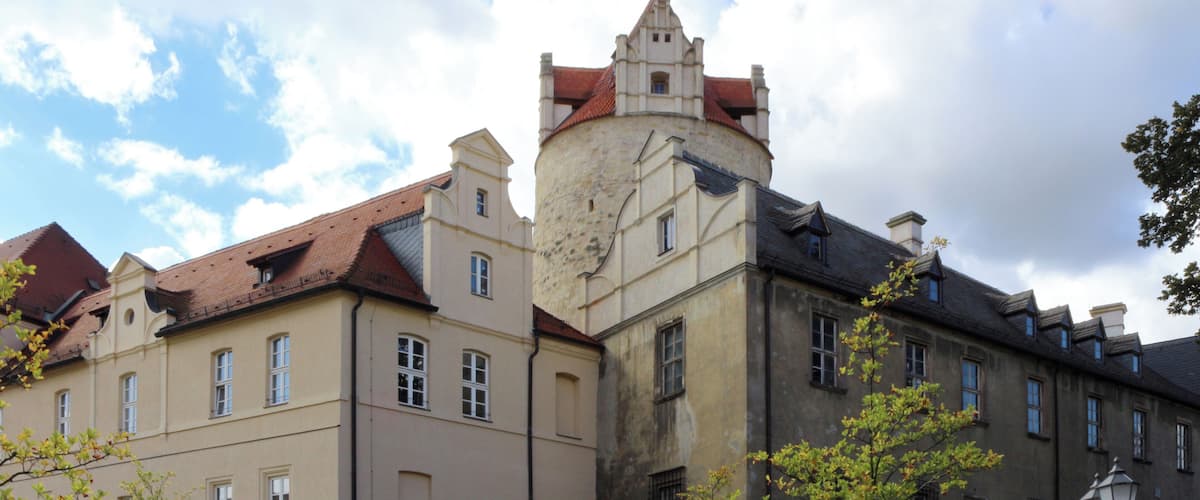 A historic building with a tower and red-tiled roof.