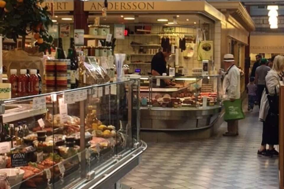 A food market with a deli counter and various food items on display.