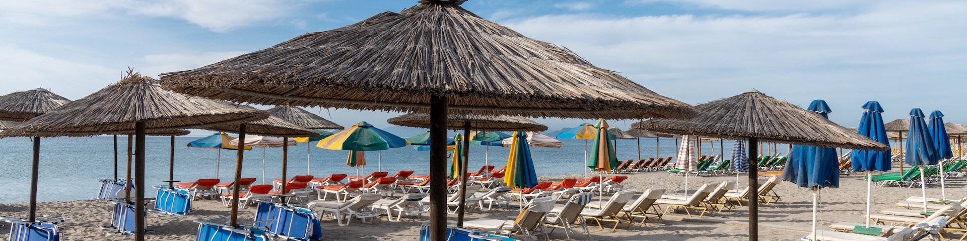 Umbrellas on Kardamena city beach in Kos island, Greece.