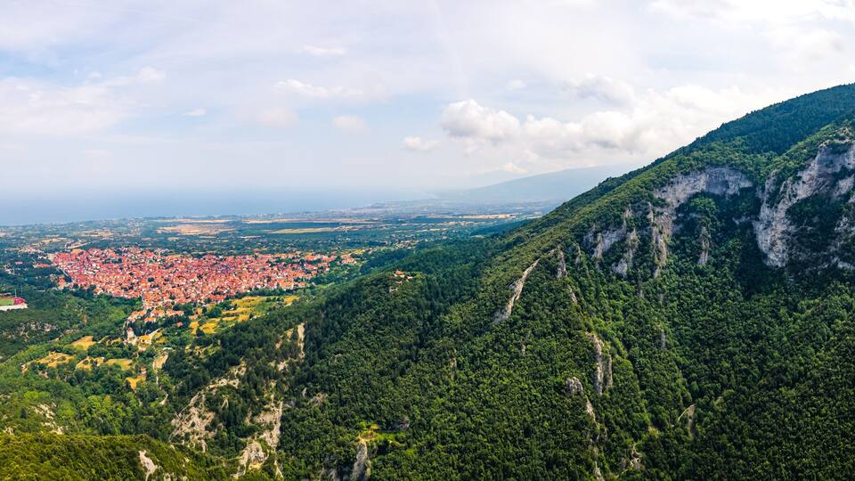 Mount Olympus, Greece. Long panoramic aerial drone shot at Leptokaria and Litochoro. Beautiful natural forests and cliff formations. High quality photo