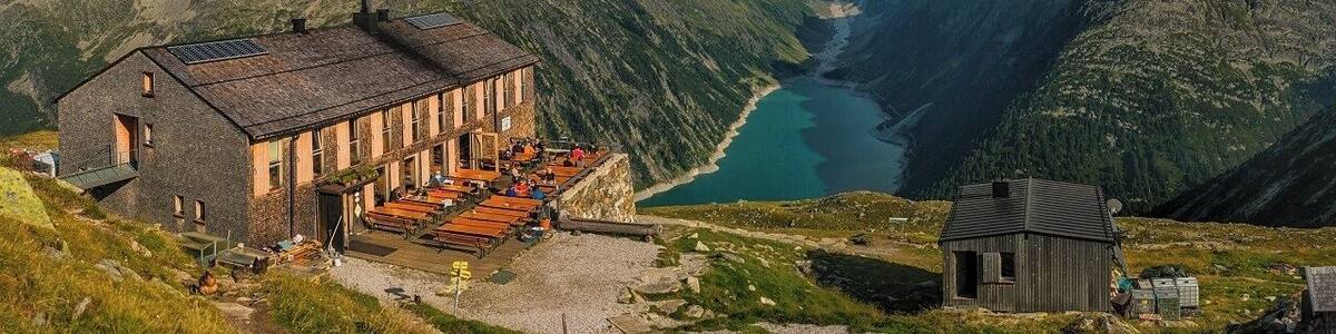August 2018
Olperer Huette, Zillertal Alps, Austria
Olperer Huette is a mountain cabin with a spectacular view of some 700 meters over Schlegeisspeicher dam lake. It is located in 2.388 meters altitude on the south side of Tuxer Kamm range which is parallel to the main Zillertal range on the border of Austria and Italy (in the picture it is the range in the background covered with low clouds). The hut offers some 70 beds to tourists who can access it either from the lake bellow or the neighbouring huts. Olperer hut was built in 1881 and it was totally reconstructed to its modern look in 2007. It is also one of the huts on the famous trekking routes called Berliner Hoehenweg or Peter Habeler Runde.