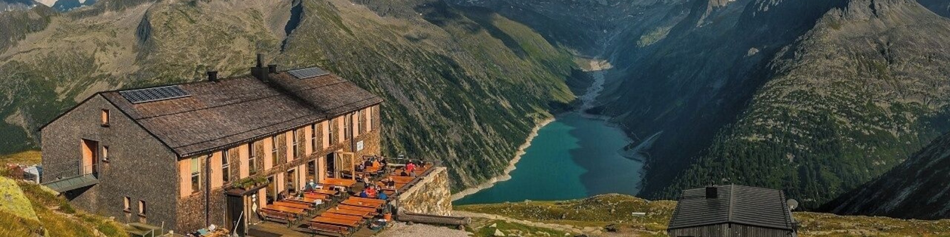 August 2018
Olperer Huette, Zillertal Alps, Austria
Olperer Huette is a mountain cabin with a spectacular view of some 700 meters over Schlegeisspeicher dam lake. It is located in 2.388 meters altitude on the south side of Tuxer Kamm range which is parallel to the main Zillertal range on the border of Austria and Italy (in the picture it is the range in the background covered with low clouds). The hut offers some 70 beds to tourists who can access it either from the lake bellow or the neighbouring huts. Olperer hut was built in 1881 and it was totally reconstructed to its modern look in 2007. It is also one of the huts on the famous trekking routes called Berliner Hoehenweg or Peter Habeler Runde.