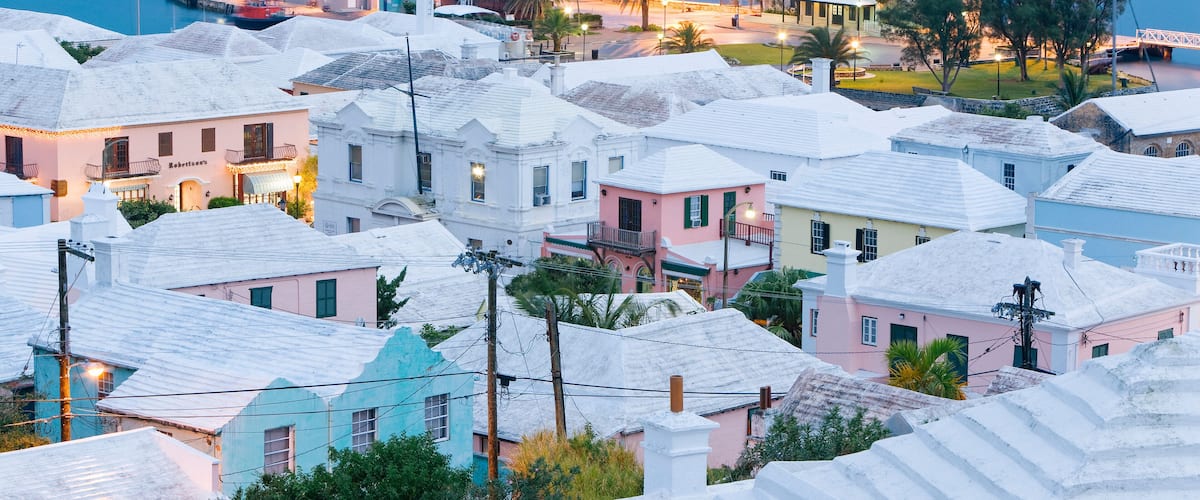 A coastal town with colorful buildings and a marina with sailboats.