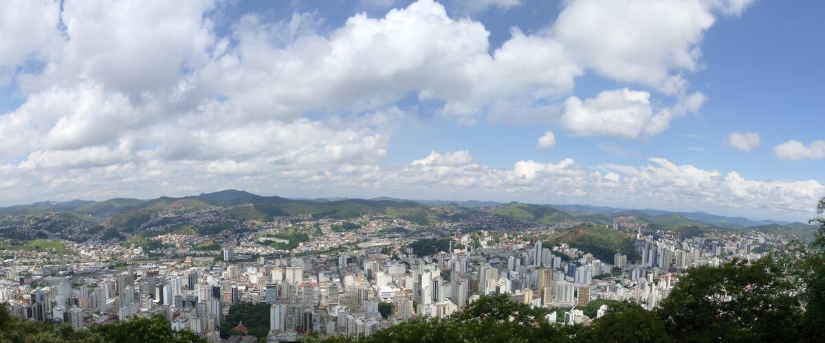 A cityscape with a mountain range in the background.