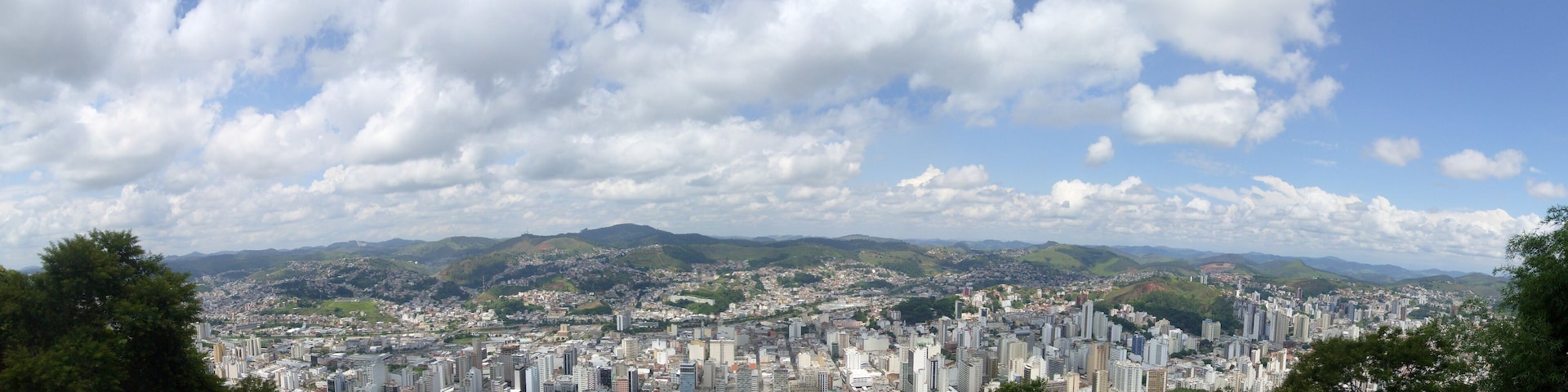A cityscape with a mountain range in the background.