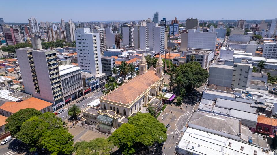 A cityscape with a prominent church, high-rise buildings, and a clear sky.