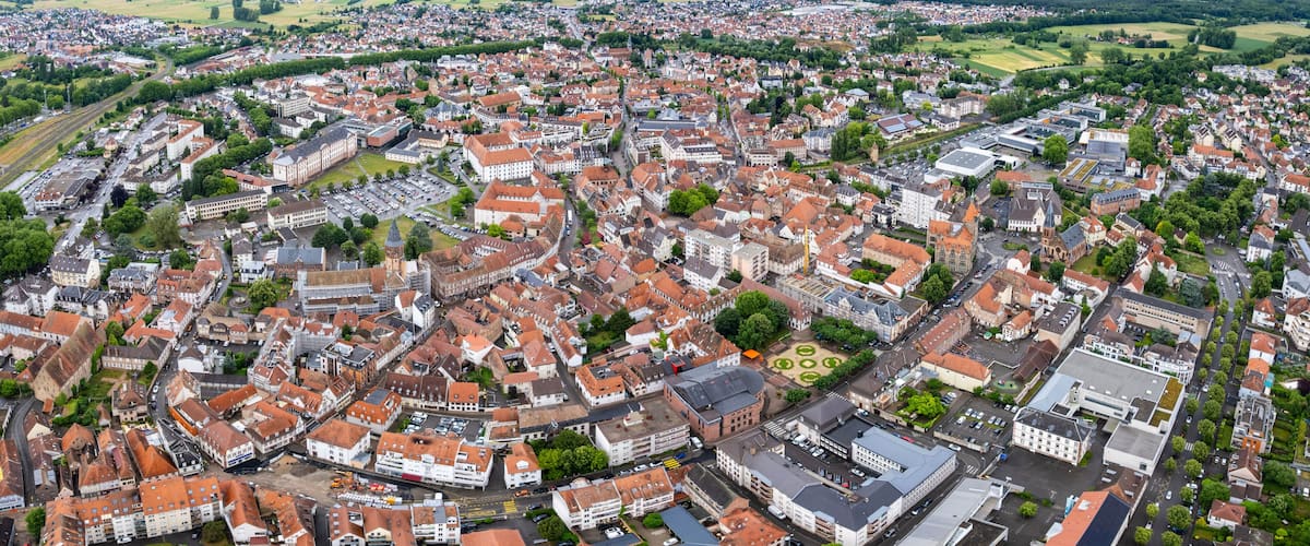 An aerial view of a densely built urban area with historic architecture and a mix of residential and commercial buildings.