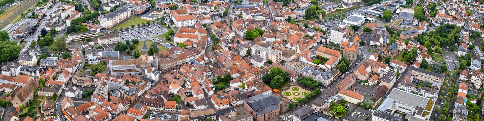 An aerial view of a densely built urban area with historic architecture and a mix of residential and commercial buildings.