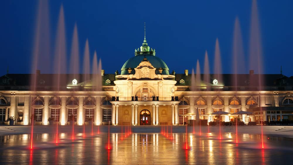 The evening view to the Kaiserpalais with a fountain in Bad Oeynhausen, Germany.