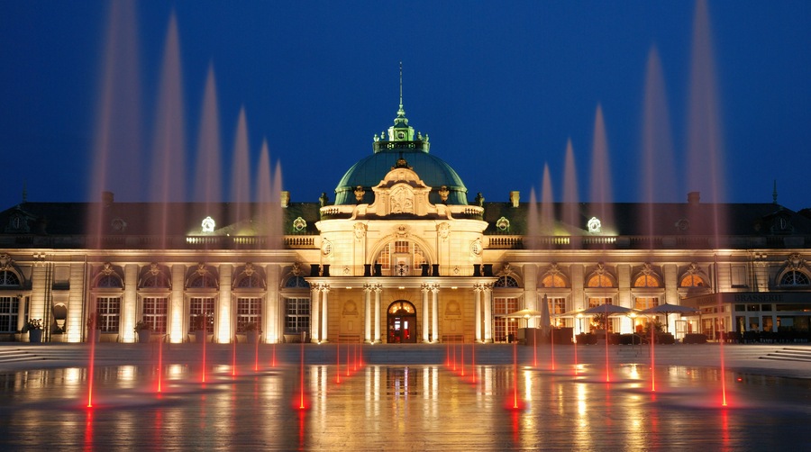 The evening view to the Kaiserpalais with a fountain in Bad Oeynhausen, Germany.