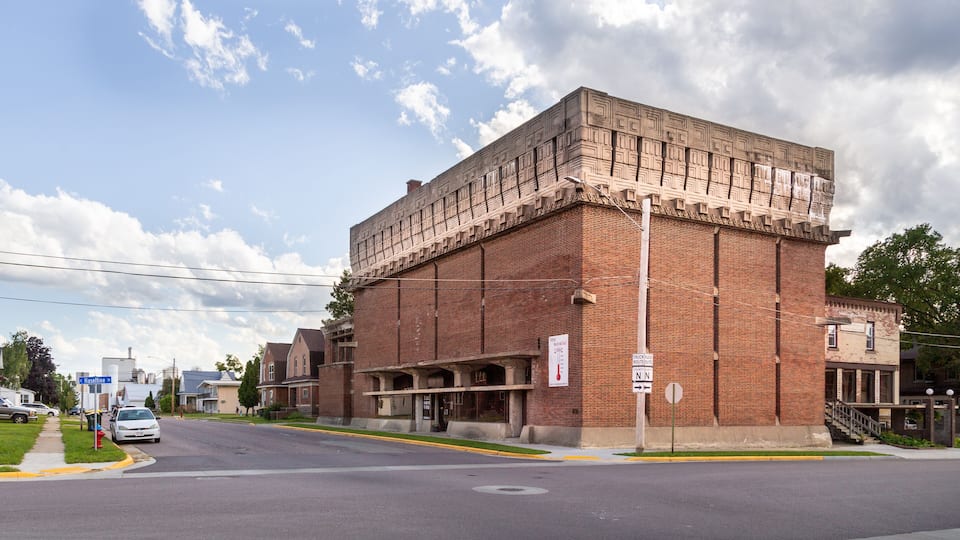 A large brick building with a unique facade and a sign indicating it is a museum.