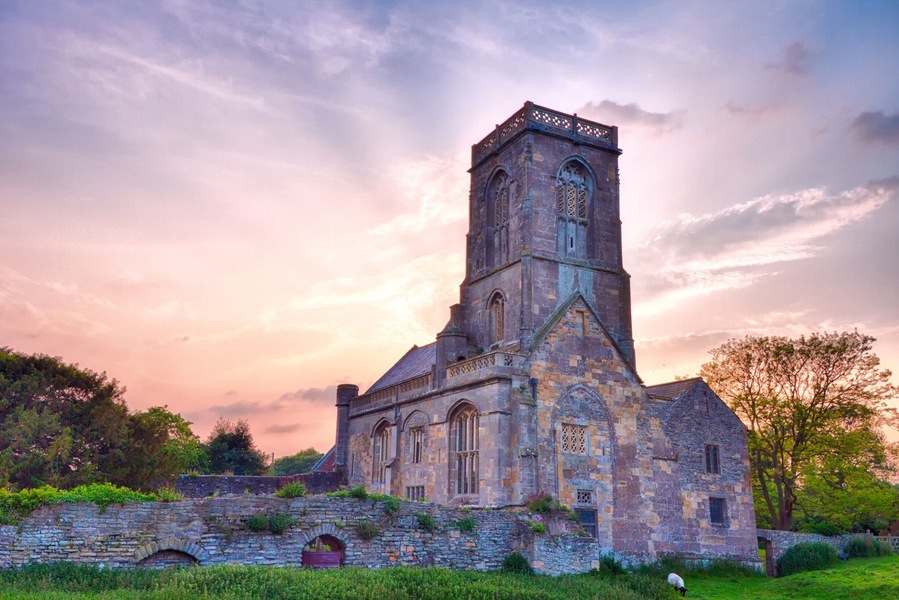 Woodspring Priory (originally Worsprynge or Worspring) is a former Augustinian priory. It is near the scenic limestone promontory of Sand Point and Middle Hope, owned by the National Trust, beside the Severn Estuary about 3 miles (5 km) north-east of Weston-super-Mare, within the English unitary authority of North Somerset. Many of the buildings are Grade I listed, and the whole site is scheduled as an ancient monument. Wikipedia