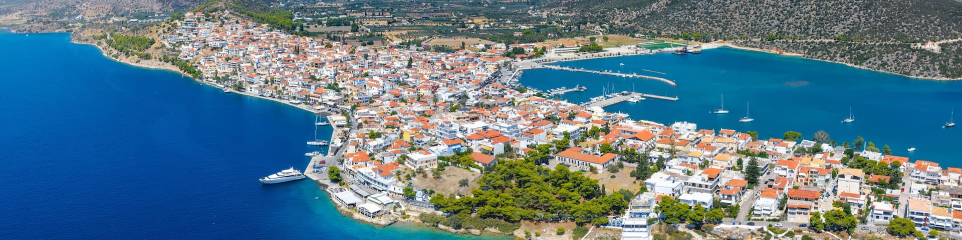 Panoramic aerial view of the town of Ermioni, situated on a peninsula with pine tree forest, Peloponese, Greece