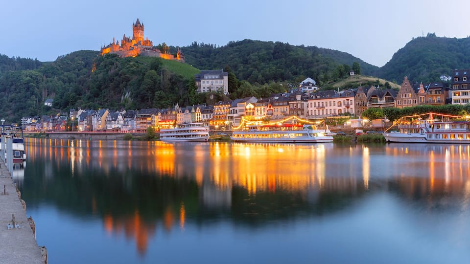 Cochem at sunset, beautiful town on romantic Moselle river, Reichsburg castle on hill, Germany