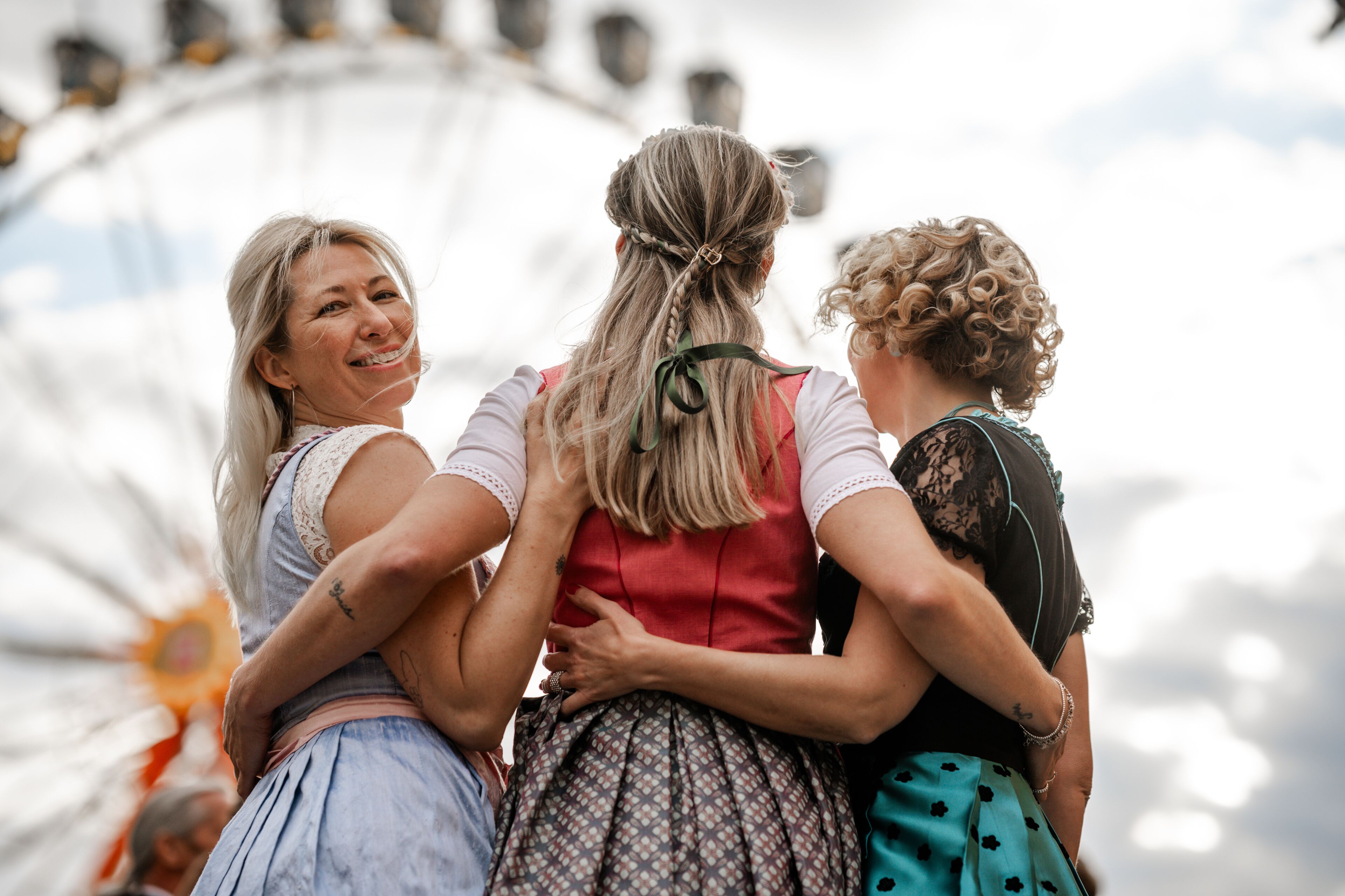 Three women in dirndls represent Bavarian tradition at folk festivals including Munich Oktoberfest Gäubodenvolksfest Straubing and Regensburg Dultfest Germany