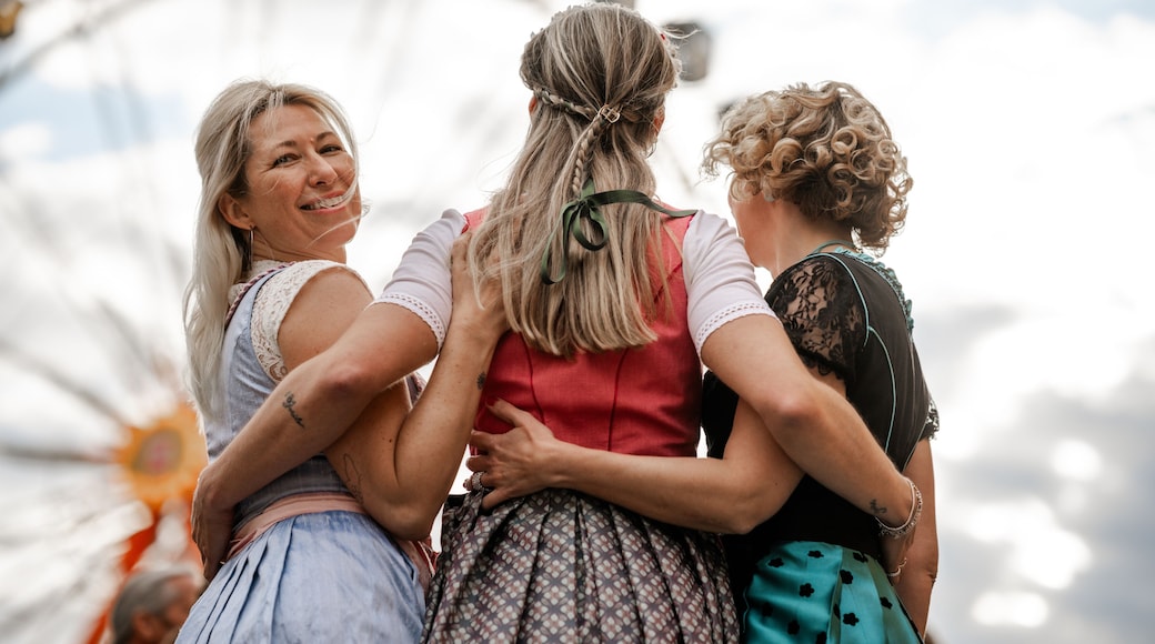 Three women in dirndls represent Bavarian tradition at folk festivals including Munich Oktoberfest Gäubodenvolksfest Straubing and Regensburg Dultfest Germany