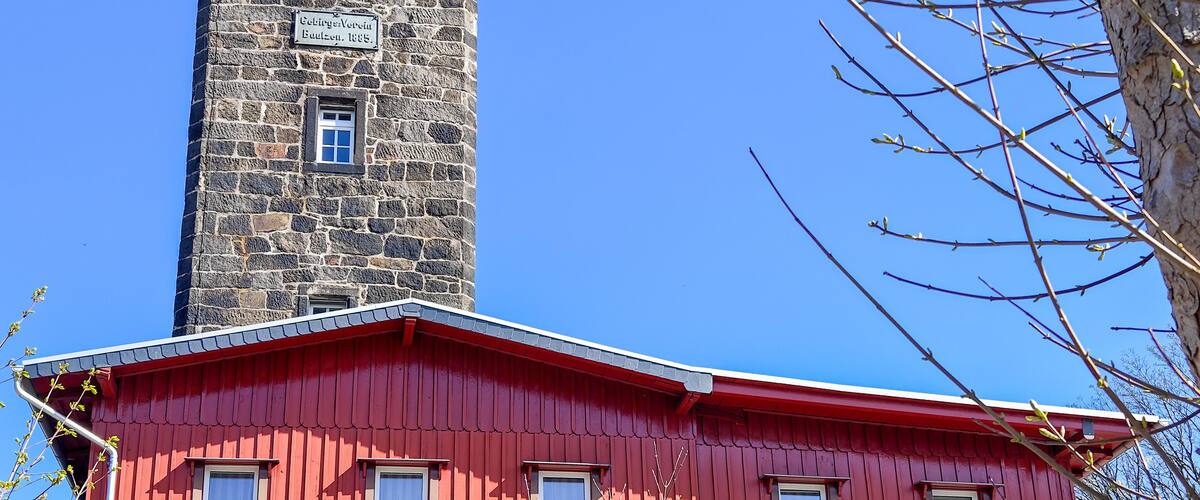 A red building with a stone tower.