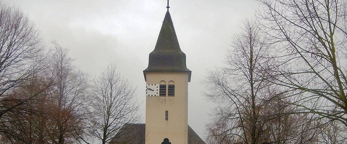 A church with a tall tower and a clock.