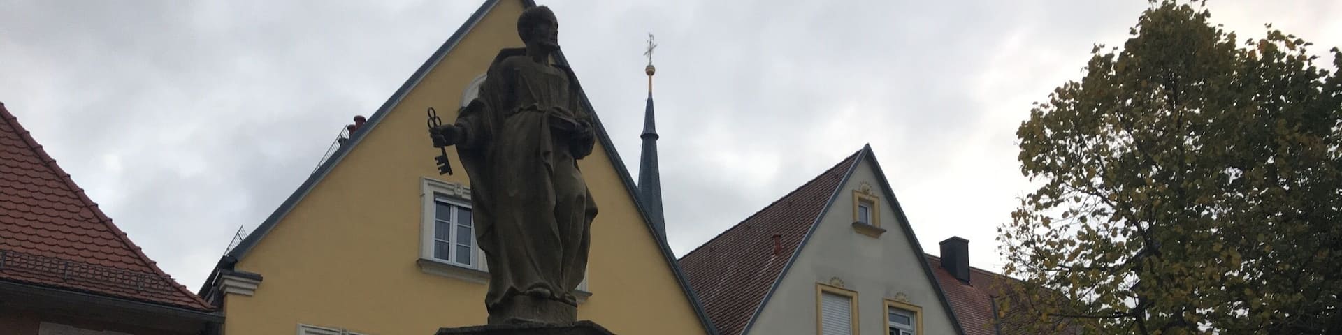 The small village of SchlĂŒsselfeld. Saint Peter statue in market square.
