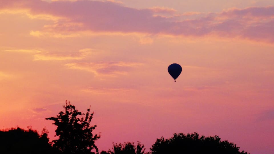 A hot air balloon against a sunset sky.