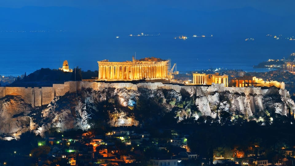 The Acropolis of Athens, including the Parthenon, on a rocky hill overlooking the city.