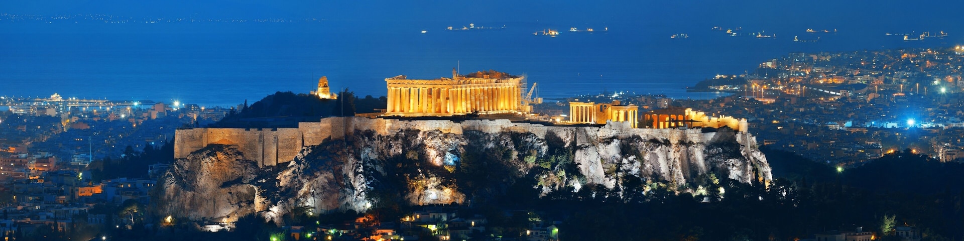 The Acropolis of Athens, including the Parthenon, on a rocky hill overlooking the city.
