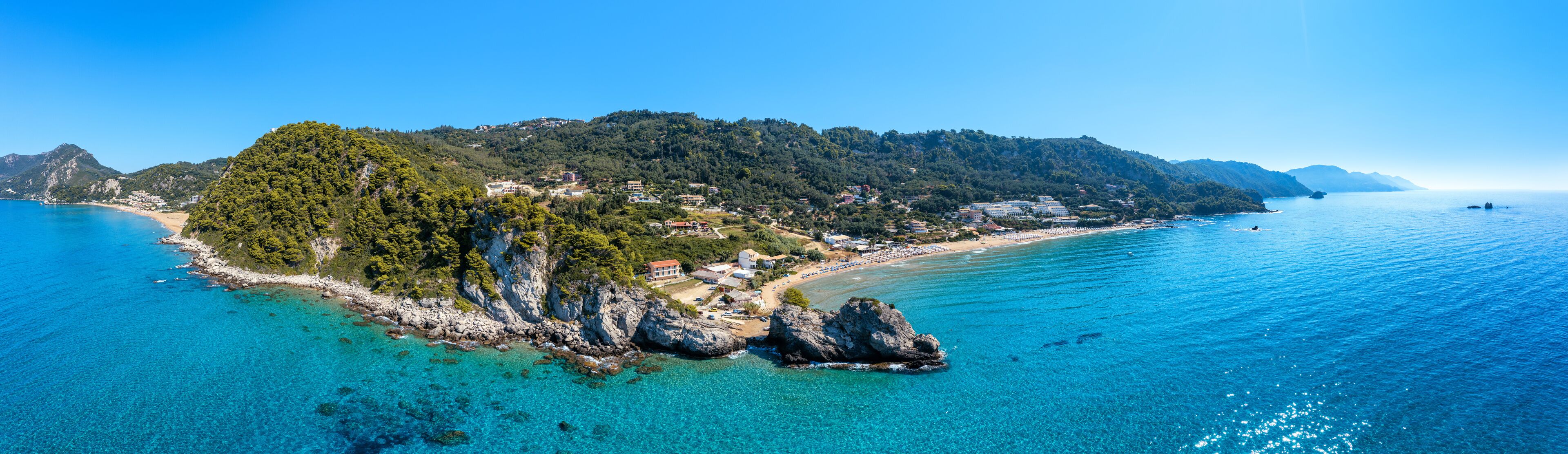 Aerial drone view over western coast and Glyfada beach, Island of Corfu, Greece. Glyfada Beach at Corfu Greece during the day.