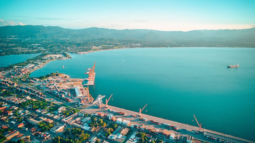Aerial of seascape washing the shore of a harbor in Puerto Cortes, Honduras