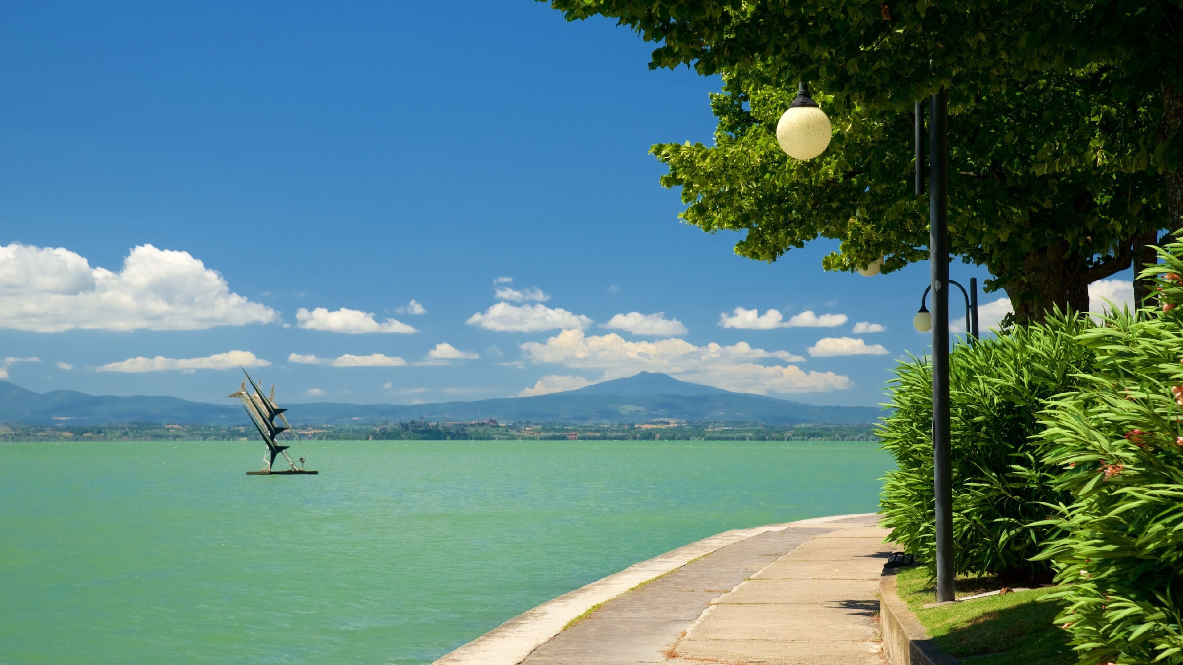 Passignano sul Trasimeno showing outdoor art and a river or creek