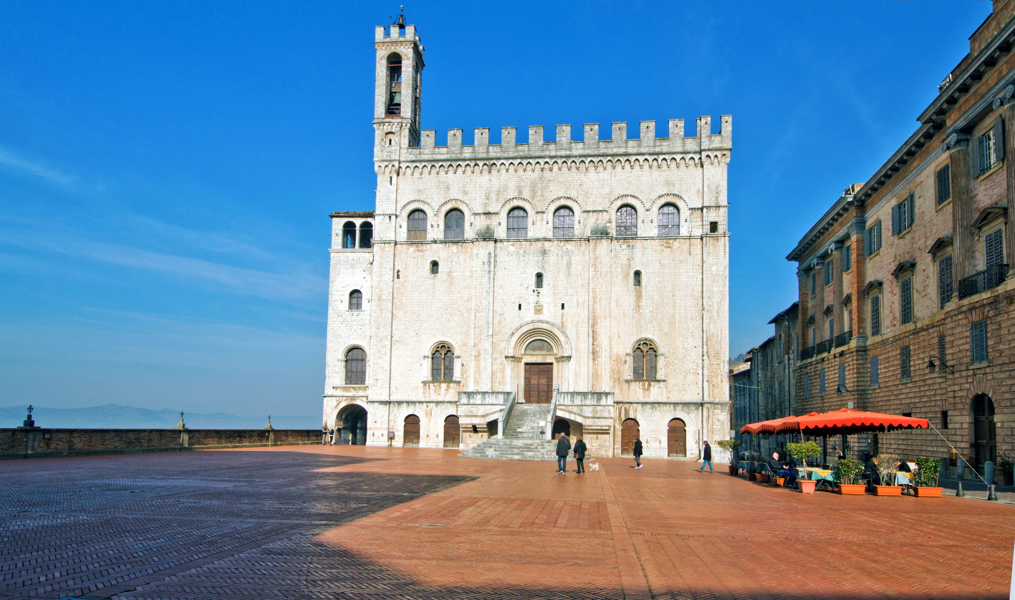 A large historic building with a prominent bell tower and arched windows.