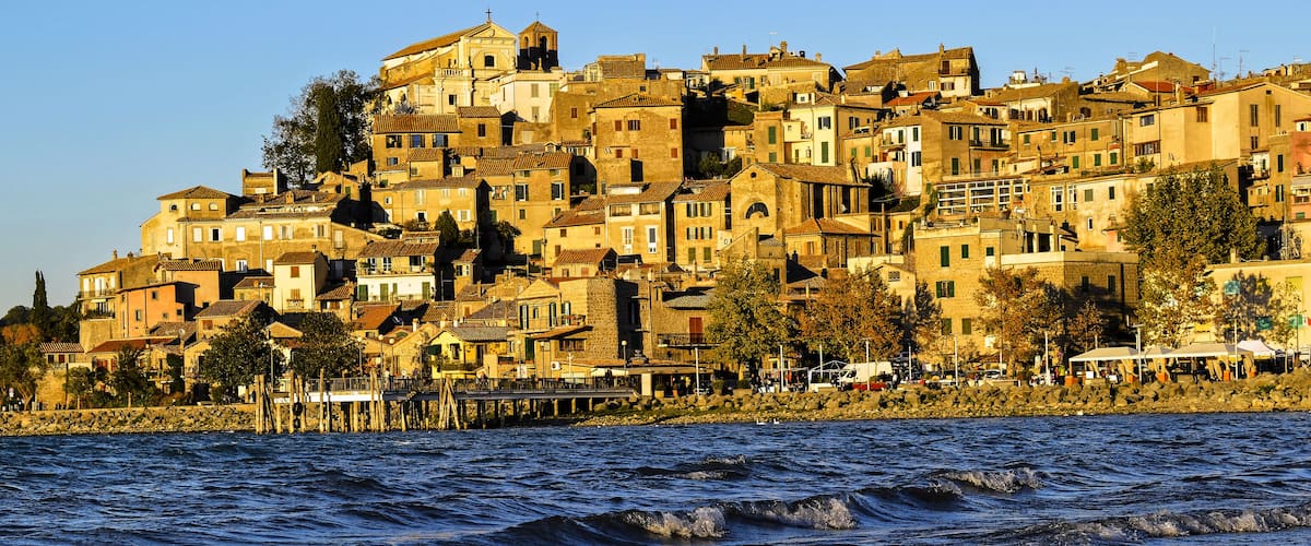 A coastal town with historic buildings and a pier extending into the water.