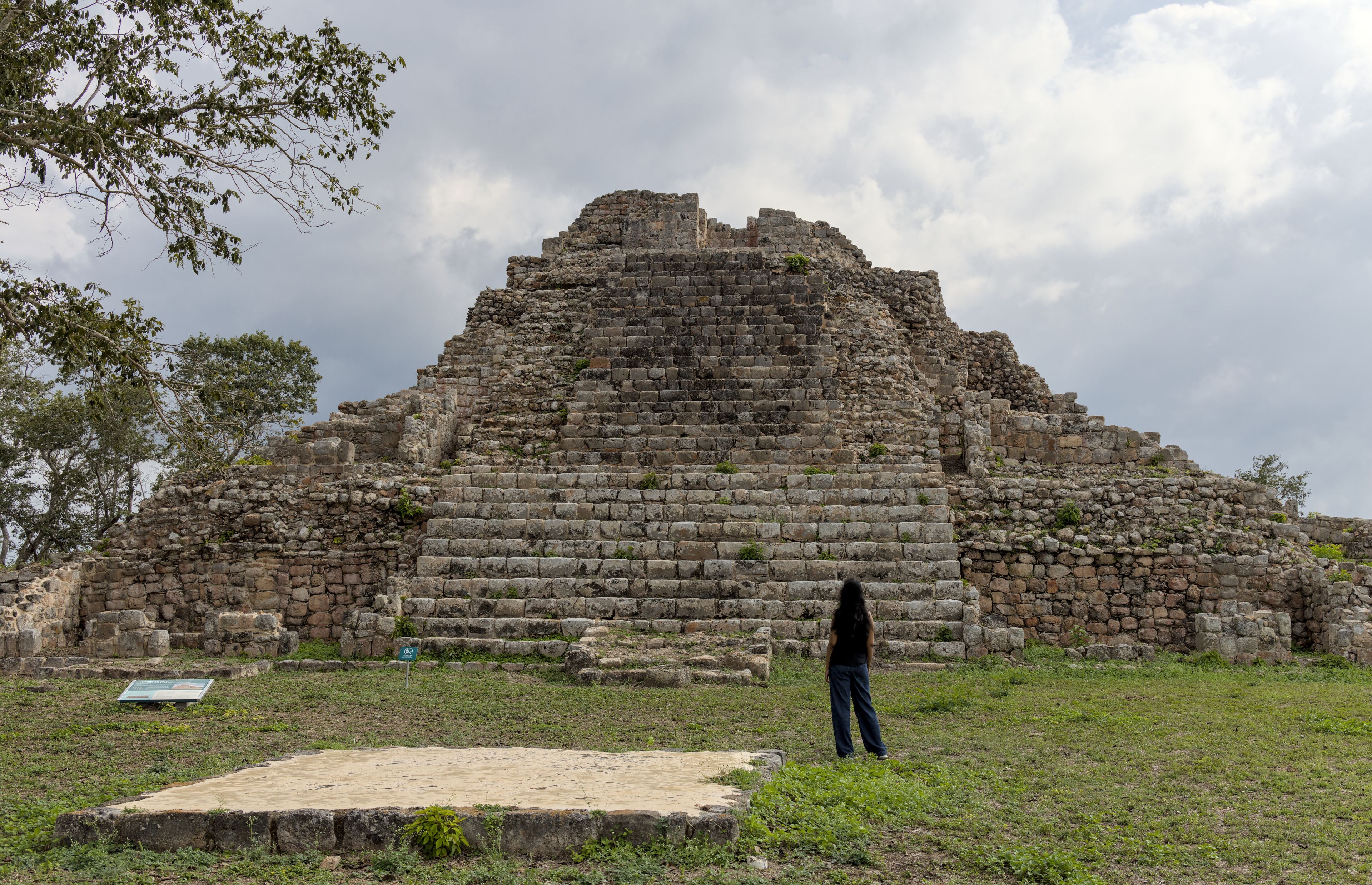 woman standing in front of ancient mayan pyramid ruins in the maya city of oxkintok in yucatan mexico (travel tourism photo blog adventure destination history tour getaway) steps historic monument