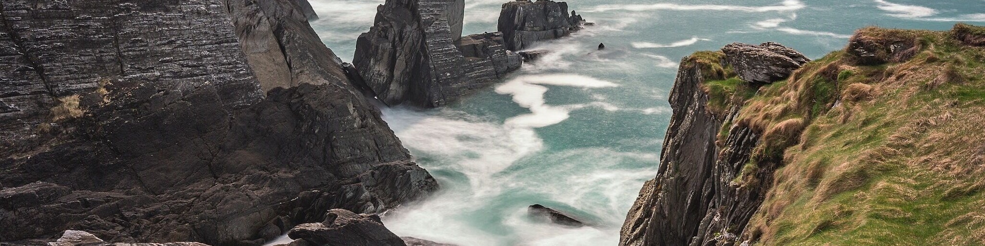 A little cove at 3 Castle Head on the Mizen Peninsular. Long Exposure to exaggerate the wave movements within the cove and on the surrounding rocks.