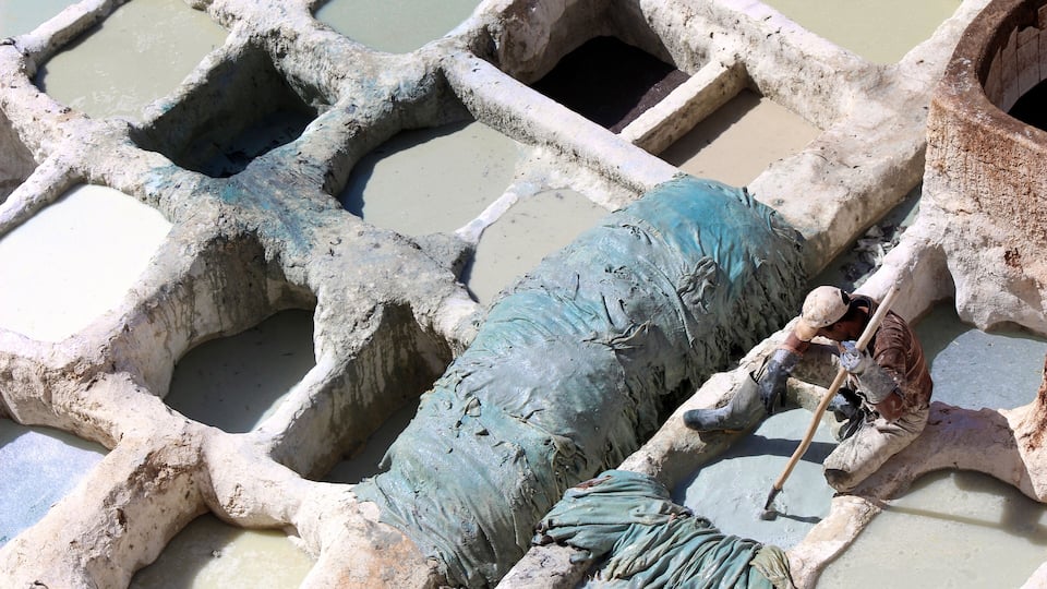 The Chouara Tannery of Fez, Morocco dates back to the 11th century, it operates much the same way it has since its inception.
In this photo a young man dyes the hides of cows, sheep, goats, and camels inside of stone vessels. The solution that they use to clean and soften the skins is a mixtures of cow urine, pigeon feces, quicklime, salt, and water. #history