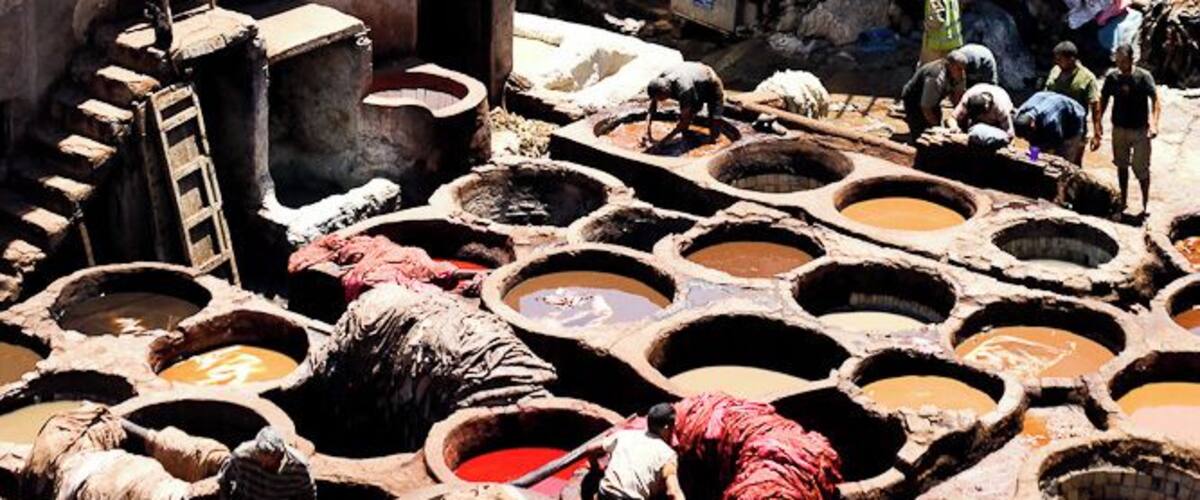 An iconic sight for sure, the tanneries of Fes was absolutely interesting to take in. As well as the smell, which wasn't as bad as I anticipated - and they gave us a bundle of mint to smell if it got too bad. :)
Here you can see all the different colors of leather dyed...and dried...and here you will find the biggest selections and best prices for leather products at the surrounding leather shops that have a veranda to see the men at work below.
Yes, yes I did acquire a bag while I was there - and it has Berber carpet on it too - double score! :)