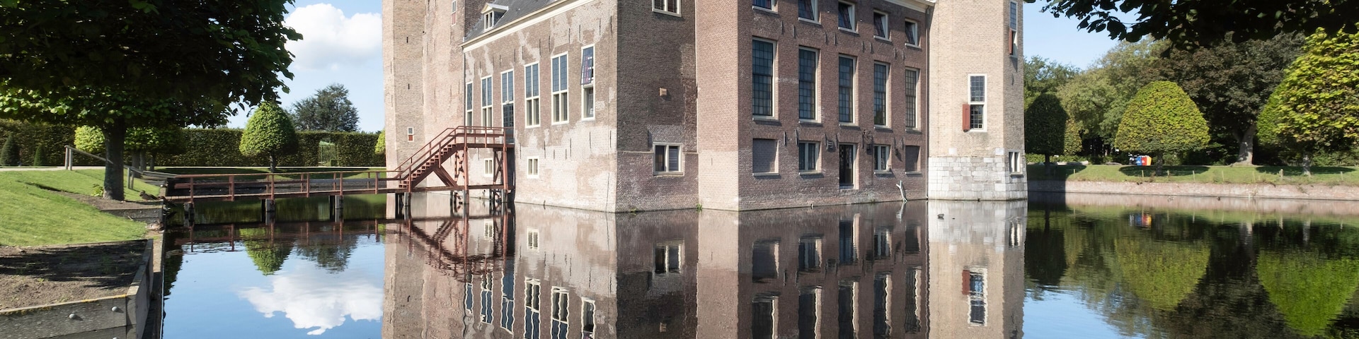 Castle Assumburg in Heemskerk near Amsterdam mirrored in the moat. The castle is nowadays a youth hostel