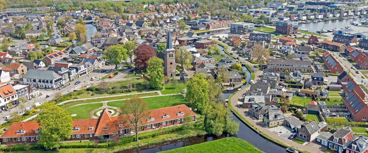 A river winding through a town with historic buildings and a church steeple.