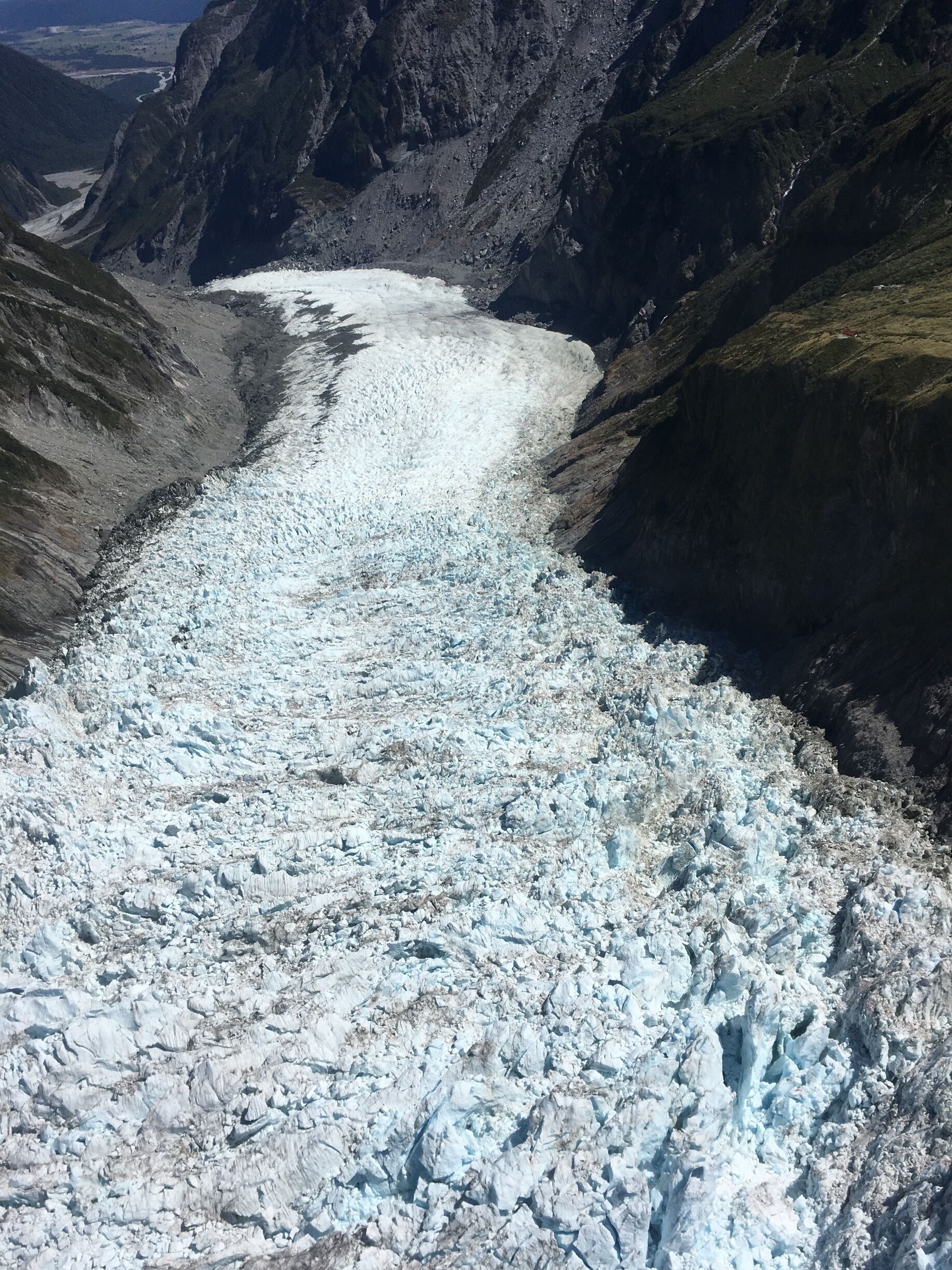 A glacier in a mountainous valley.