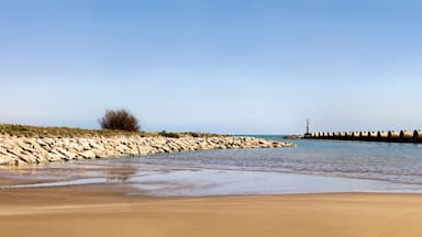 Panorama view of the breakwater in Les Salines beach in Cubelles, Barcelona, Spain. Mediterranean summer day in Garraf coast.