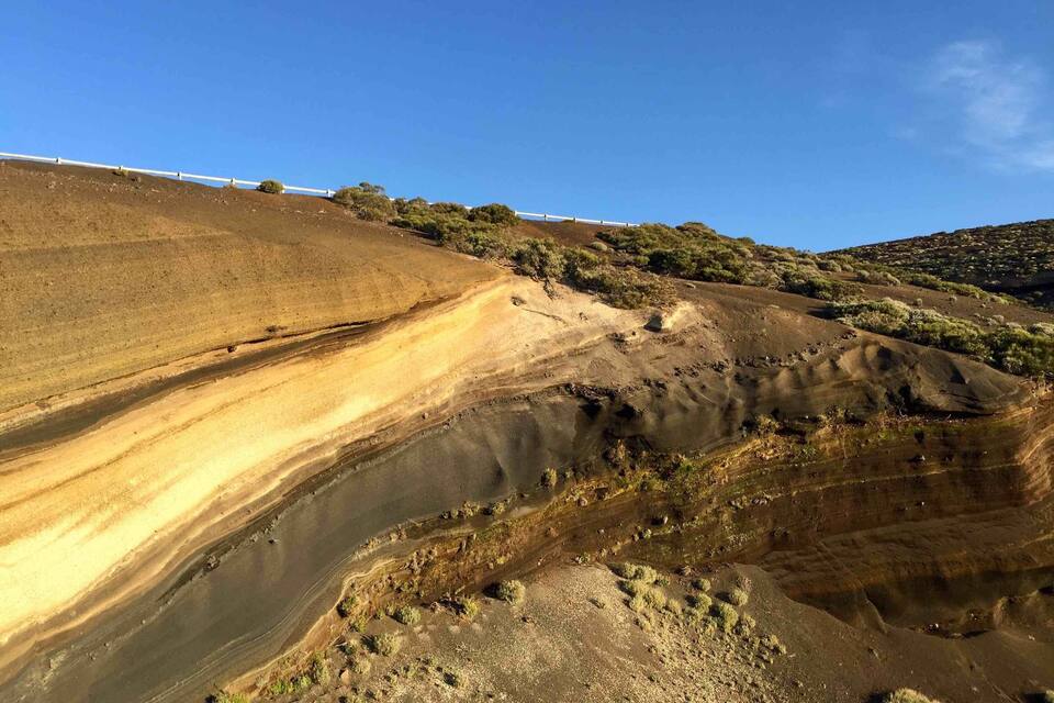 A rugged landscape with layered hills and sparse vegetation.