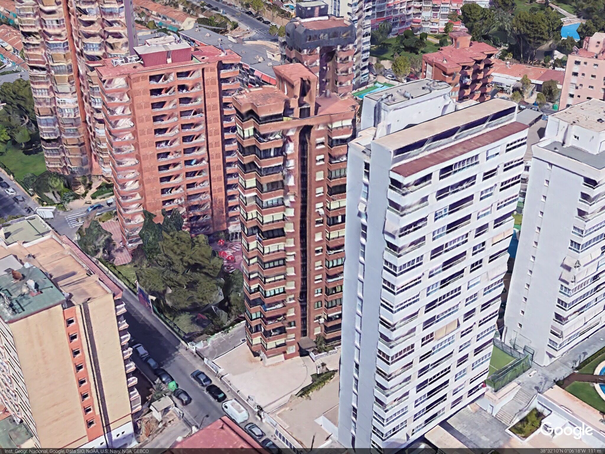 The penthouse flat we rented is the brown one immediately behind the white building. The outside space was superb and HUGE. Terrific views all over the city,the sea and the nearby mountain.  A very short walk to shops,restaurants and beach. 