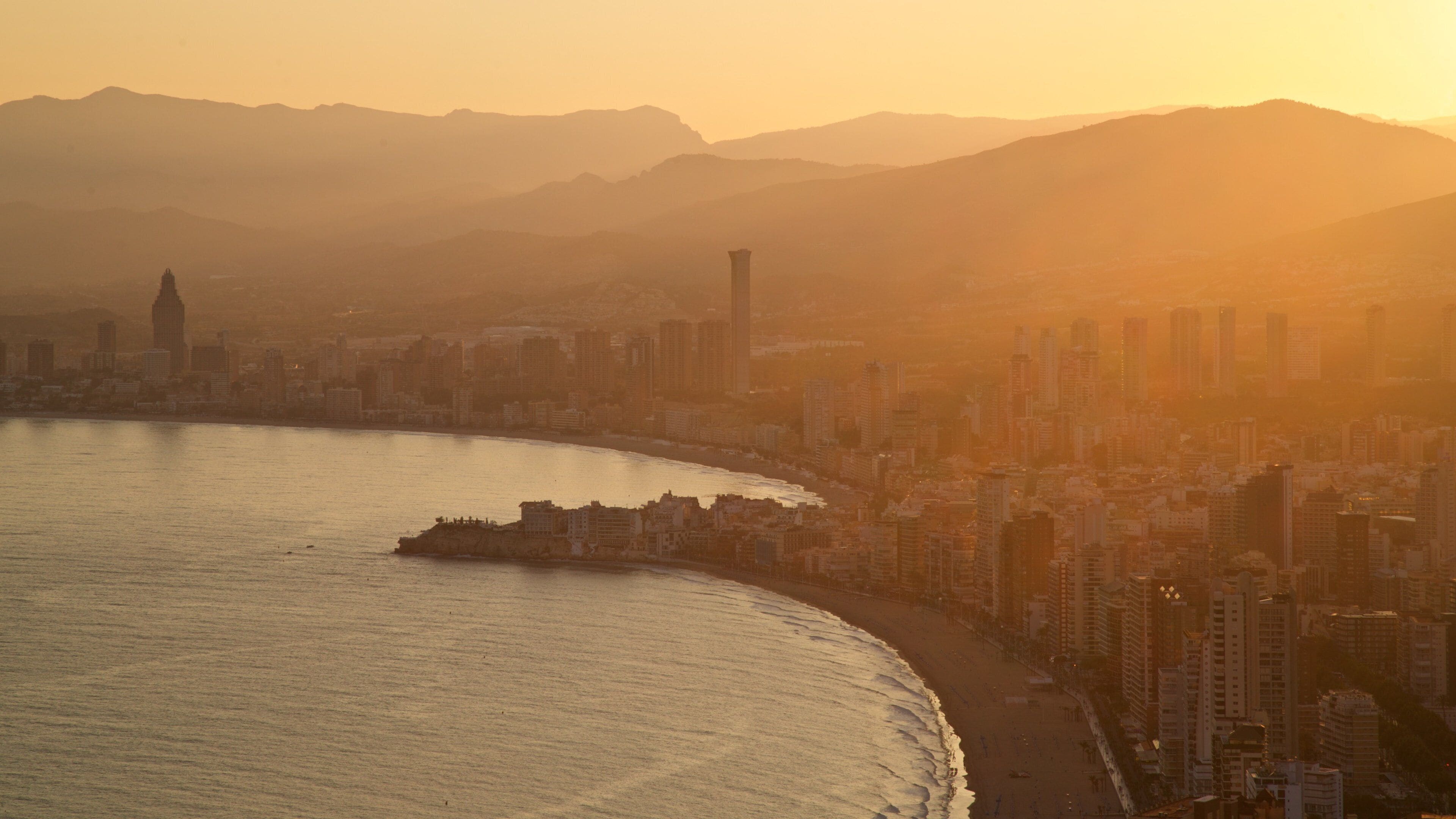 Benidorm which includes a coastal town, a sunset and general coastal views
