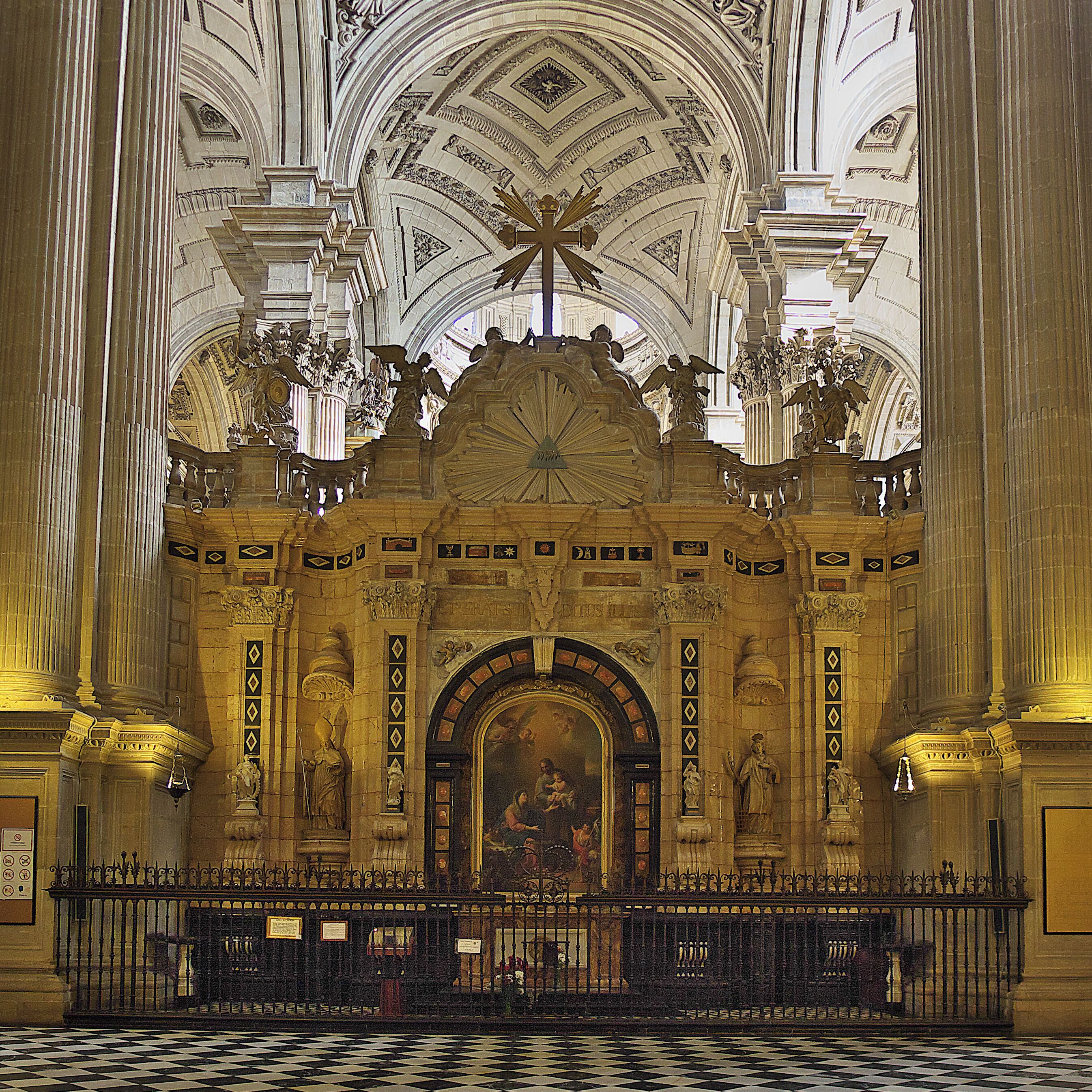 An ornate church interior with high ceilings, detailed sculptures, and a checkered floor.