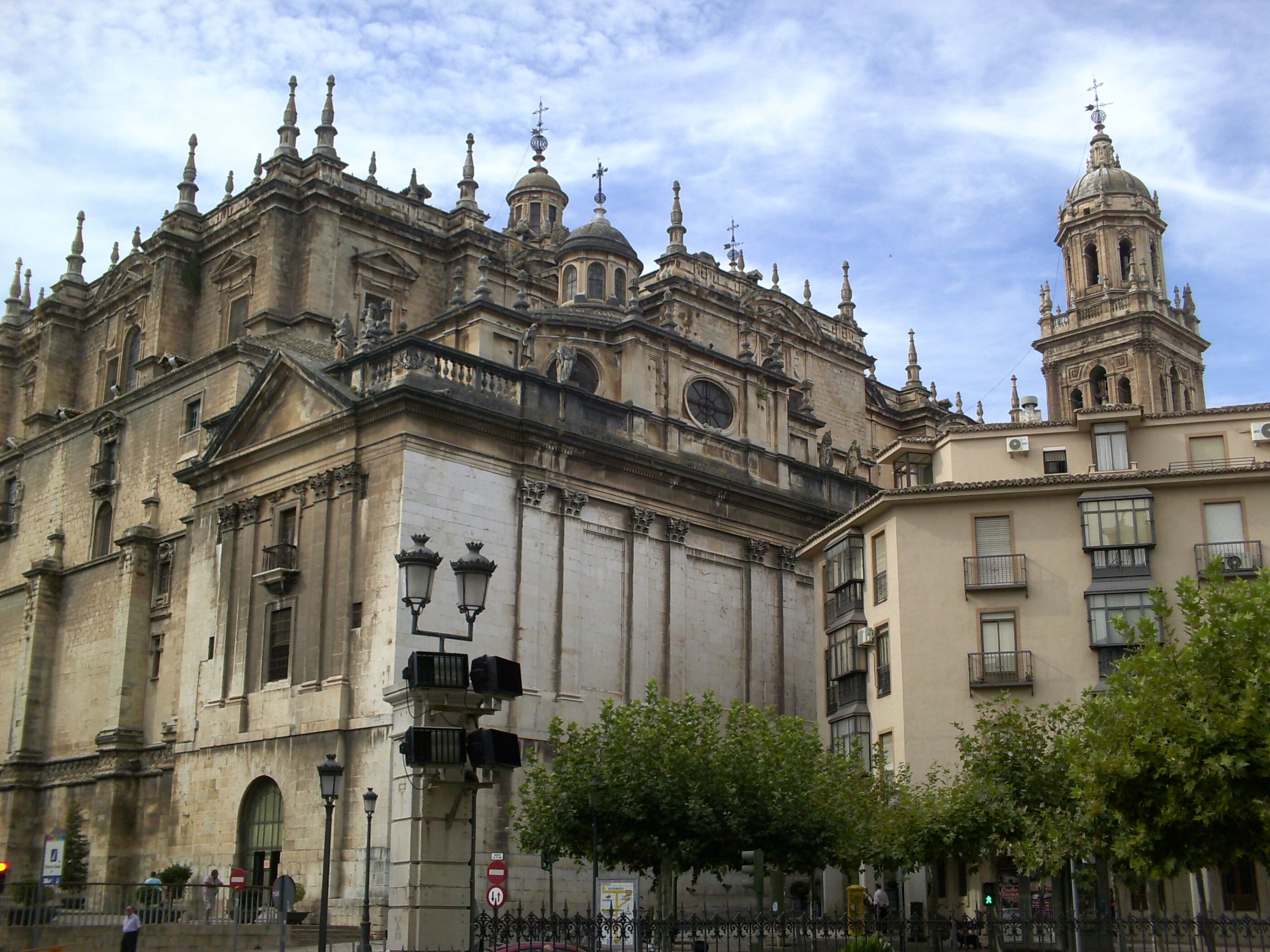 A historic cathedral with ornate architecture, including domes and spires, and a clock tower.