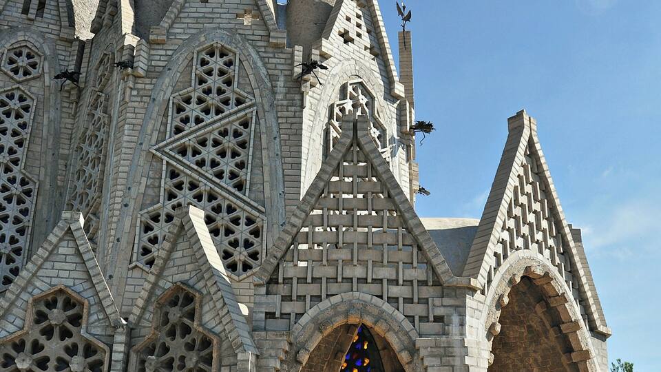 A Gothic-style building with intricate brickwork and pointed arches.